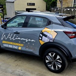Branded car parked outside garage