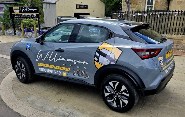 Branded car parked outside garage